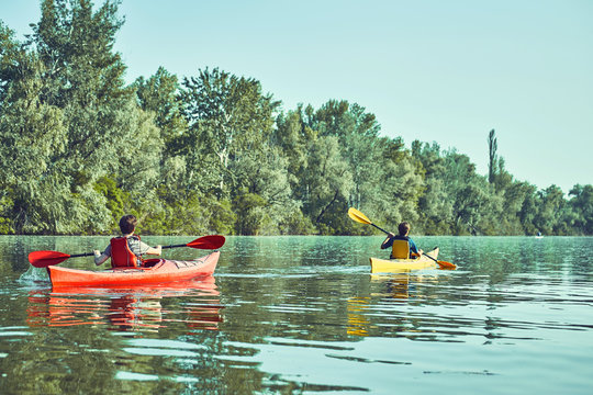 A canoe trip along the river along the forest in summer.