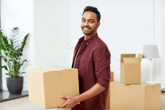 happy man with box moving to new home