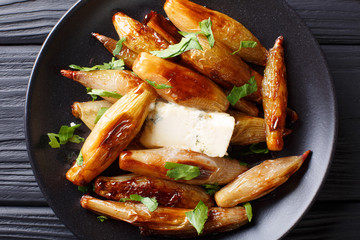 whole caramelized balsamic shallots with blue cheese and parsley close-up. horizontal top view