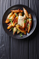 Crispy caramelized onions shallot with blue cheese and parsley closeup on a plate. Vertical top view