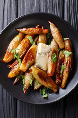 whole caramelized balsamic shallots with blue cheese and parsley close-up. Vertical top view