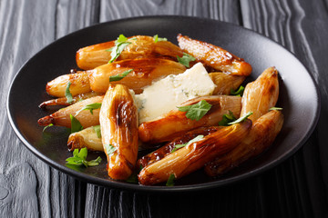 Delicious food: caramelized balsamic onion with blue cheese and parsley closeup on a plate. horizontal