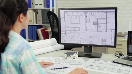 rear view of woman architect working with computer - Powered by Adobe