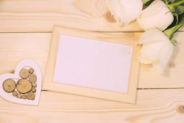 White roses on natural wooden background