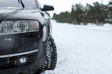 close-up of a man, cleans headlamp from snow