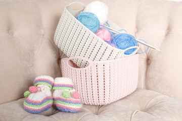 Knitting baby shoes, pregnant homemade work concept