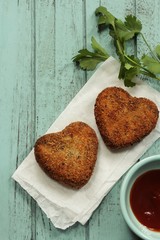Homemade heart shaped Lamb meat cutlets / Valentines day food overhead view
