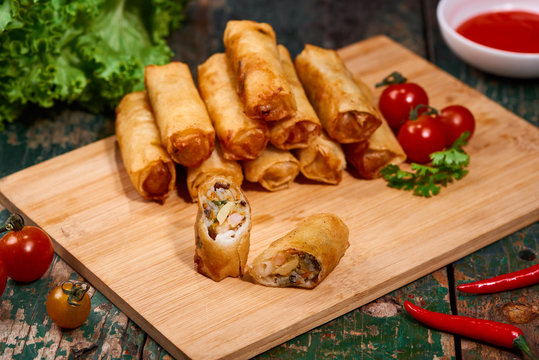 Vietnamese food. Delicious homemade spring rolls on wooden table.