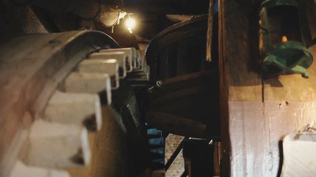 4K Huge wooden windmill cogwheels turning slowly. Traditional old Dutch mill mechanism inside close-up gears spinning.