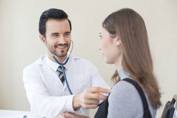 Doctor using stethoscope for listening woman. People with medical concept.