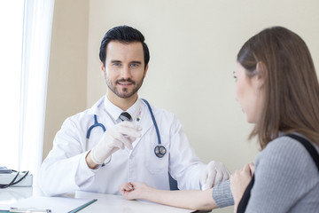 Fototapeta premium Doctor inject woman at hospital. People with medical concept.