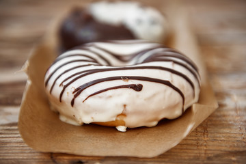 Macro shot of fresh baked doughnuts on wooden background. 