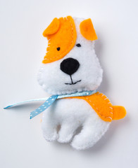 A dog from felt on a white background. The symbol of the year.