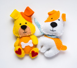 A dog from felt on a white background. The symbol of the year.