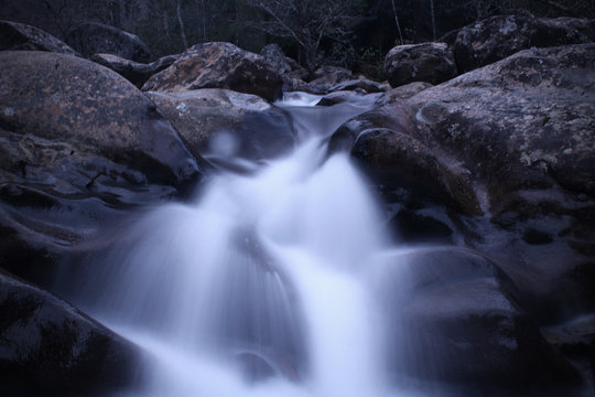 Slow Shutter Speed Photography of a Rushing Waterfall of River Rocks