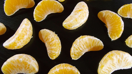 The Mandarin slices on a black background.