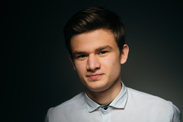 Obraz premium young brunette guy in a white shirt