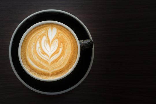 Latte are aromatic cappucino coffee serve in a black cup