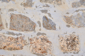 Rough stone wall of an old village stall