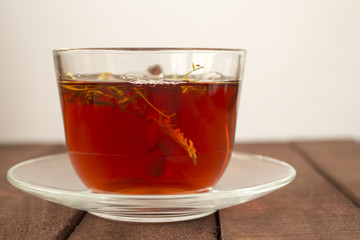 Tea Cup on a brown wooden Board