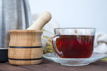 Cup of tea with a mortar and pestle