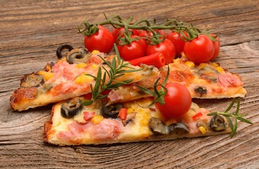 Delicious pizza served on wooden table