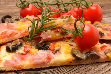 Delicious pizza served on wooden table