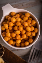 Top view on white cup full of fried chickpeas