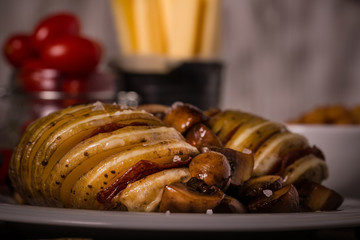 Two roasted potatoes with gouda cheese and salami
