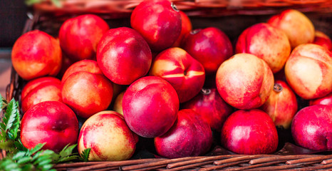 Organic fresh ripe peaches  a local farmer market.  Nectarines on display stall. Healthy local food market concept.