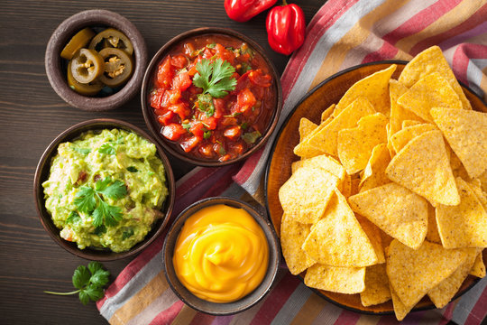 mexican nachos tortilla chips with guacamole, salsa and cheese dip
