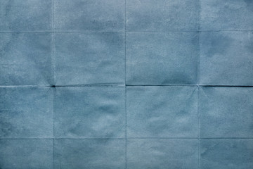 Old crumpled sheet of paper, texture blue background