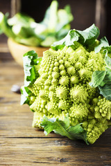 Raw fresh Roman cauliflower on the wooden table