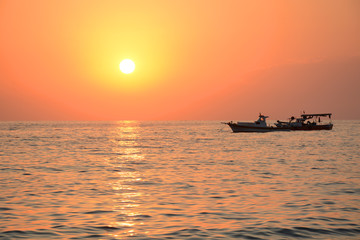 Fototapeta premium Mediterranean Sea sunset and boat floating