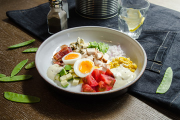 Healthy Hearty Cobb Salad with Chicken, Bacon, Tomato, Onions, Eggs, green beans. American food. Close up, home made