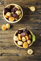 Sweet italian dried figs, apricots and dates on the wooden table
