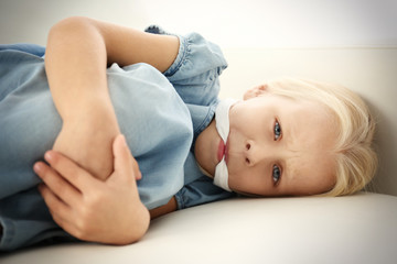 Helpless little girl lying with gag in mouth. Child abuse concept - obrazy, fototapety, plakaty