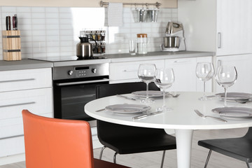 Fototapeta na wymiar Modern kitchen interior with served table and electric oven