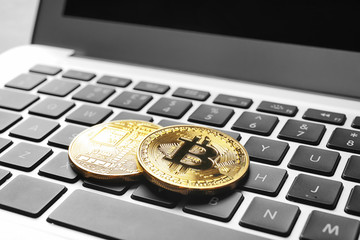 Golden bitcoins on computer keyboard