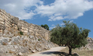 vegetation of Greece near the ruins of ancient Greek buildings.