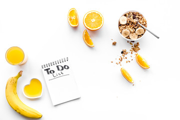 Morning habits of successful people. Healthy breakfast porridge with fruits and planning the day. White background top view