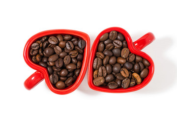 red cups in the form of hearts with coffee beans on white background