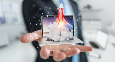 Businessman with rocket launching from a laptop 3D rendering