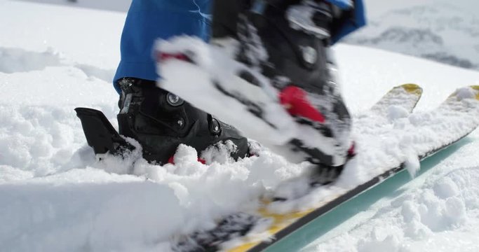 Detail of boot walking up along snow landscape.Mountaineering ski activity. Skier people winter sport in alpine mountain outdoor.Slow motion 60p 4k video