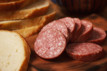 Closeup smoked beef sausage sliced with bread