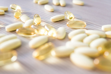 Selective focus of omega 3 and magnesium pills on a table.