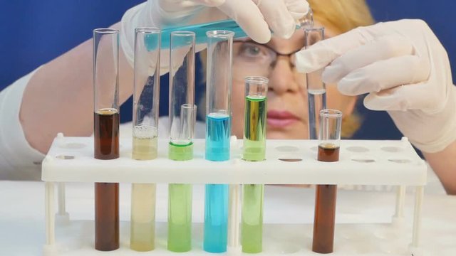 Medical worker makes analyses with tubes