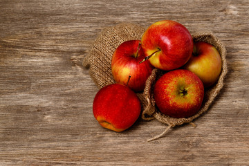 Juicy red apple on an old wooden background
