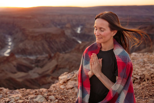 Woman with inner peace praying and  meditating at dawn dusk in m