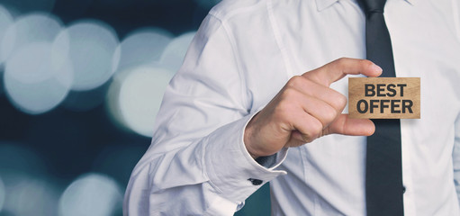 Man holding best offer text on a wood cube.